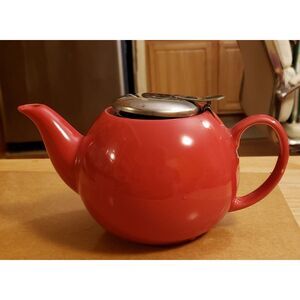 Teapot red for one, plus strainer. Great holiday color! Preowned